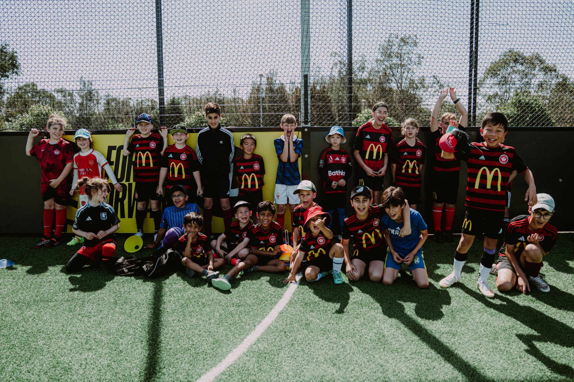 Junior players celebrating together on the pitch